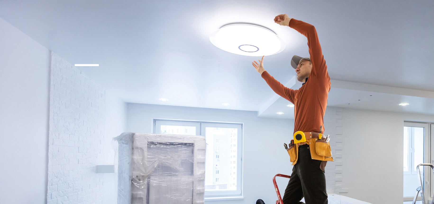 Electrician installing pendant lights in a home